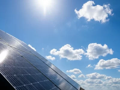 Solar panels angled toward a bright blue Florida sky — powering net-zero homes in Florida