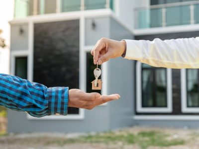 person getting the keys in front of their new home in FL